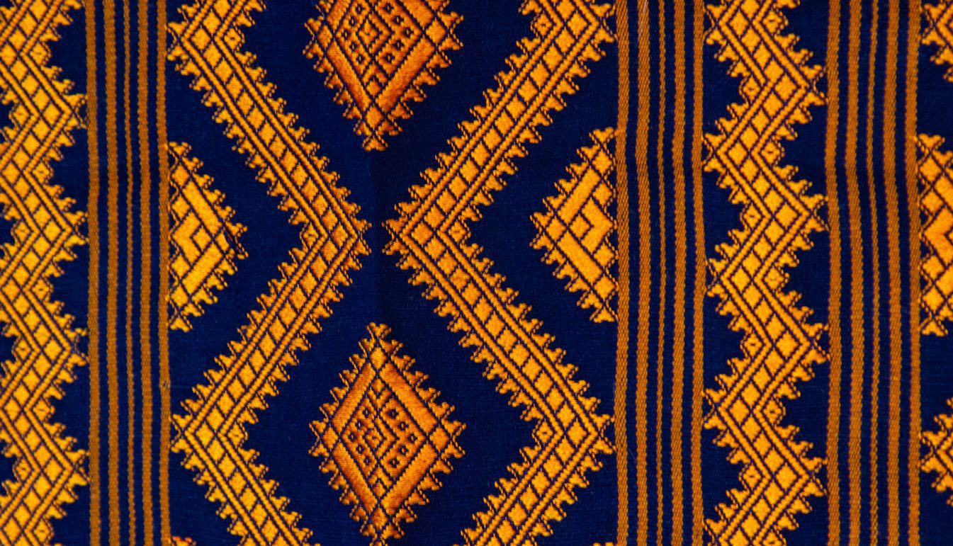 Closeup of Large Rectangular Textile with Orange and Purple.