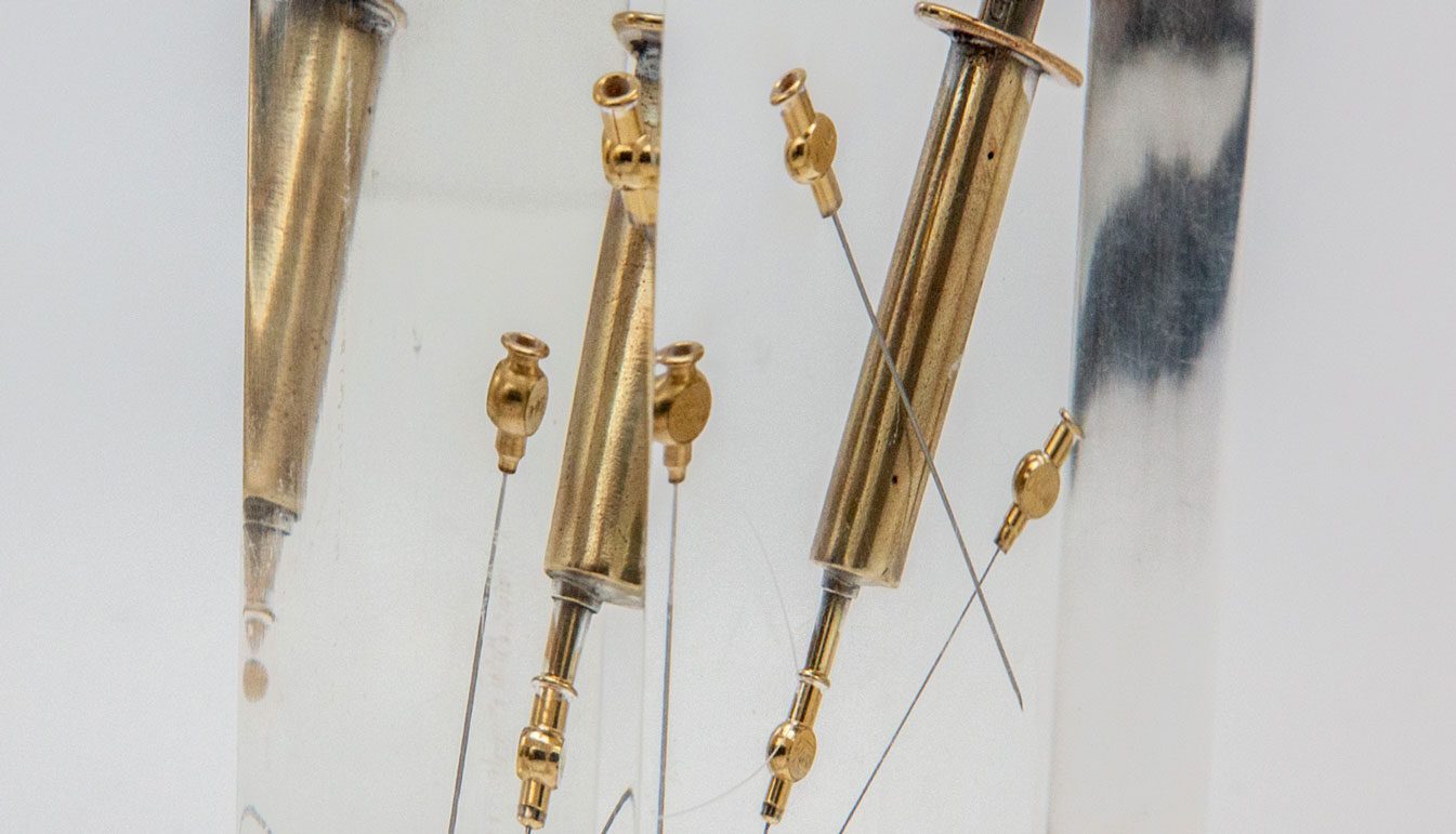 Gold-syringe-in-lucite