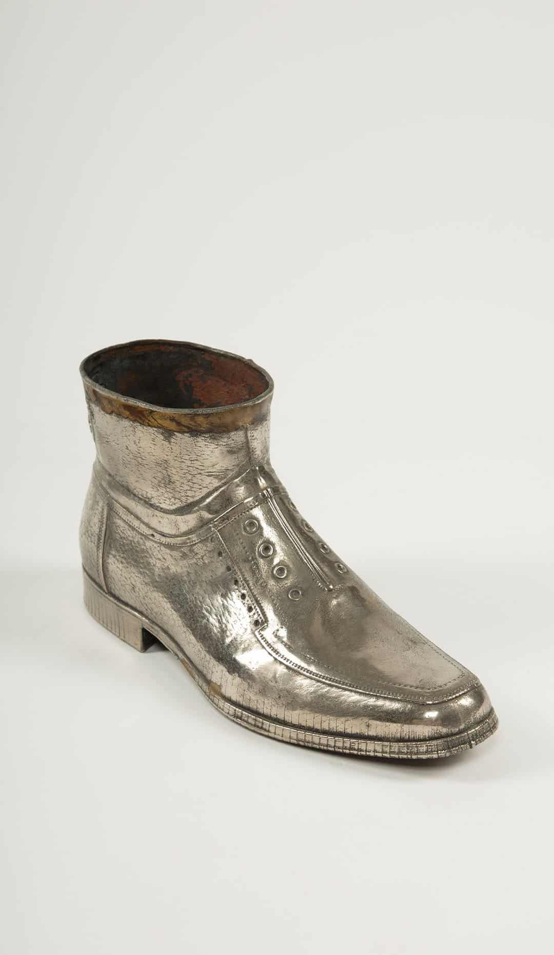 Sculpted Sole: Novelty Metal Boot with Industrial Markings